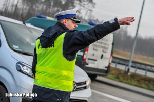 policjant wskazuje drogę kierowcy