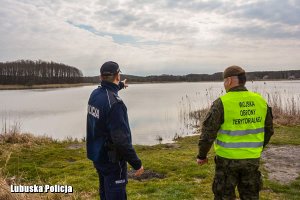 policjant i żołnierz patrolują rejon jeziora