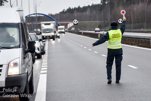 Funkcjonariusz Inspekcji Transportu Drogowego zatrzymuje pojazdy do kontroli